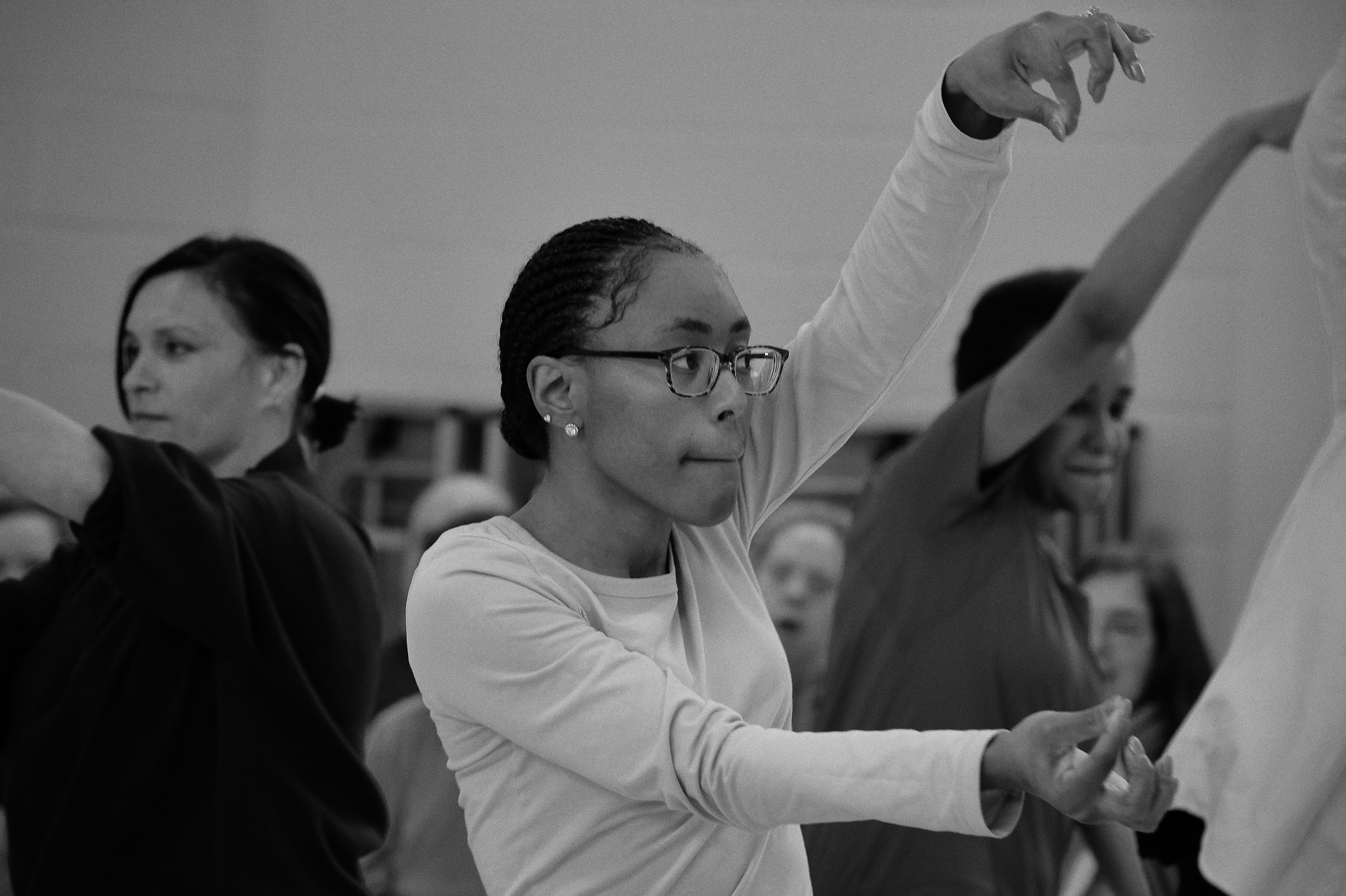 Black and white photo of Nicole dancing at Professional Development Class sharing 